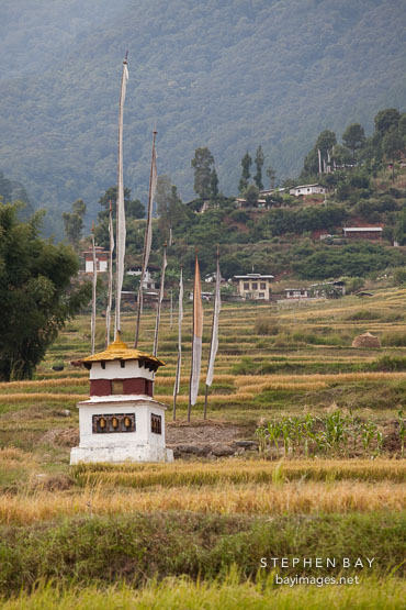 Chorten and prayer flags in fields of Sopsokha, Bhutan.