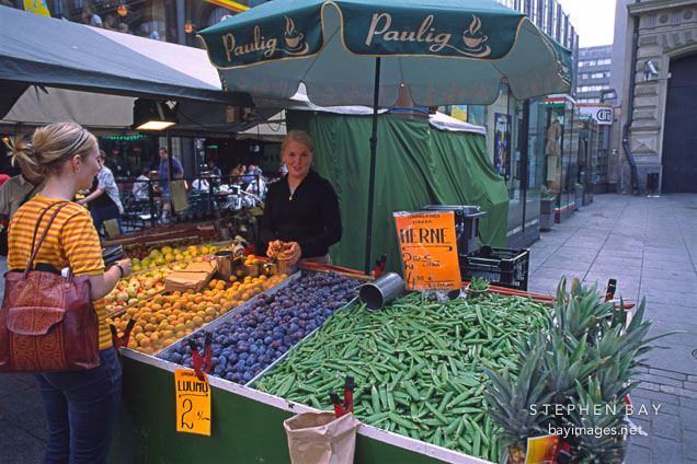 Young woman selling vegetables. Helsinki, Finland.