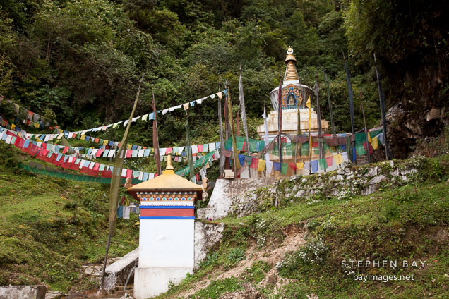 Chorten and prayer flags along side the road.