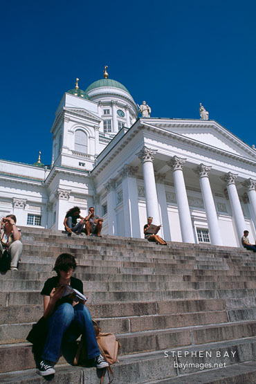 Girl reading on the steps of the Cathedral. St. Nicholas' Church. Helsinki, Finland