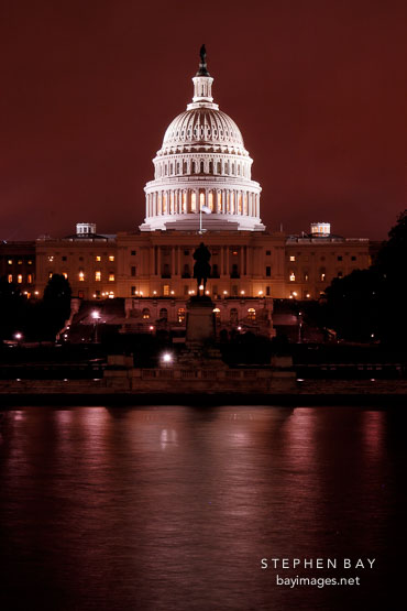 U.S. Capitol at night with the Capitol reflecting pool. Washington, D.C., USA.