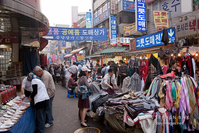Stores selling shoes, scarves and clothes attract many shoppers at the Namdaemun Market in Seoul.