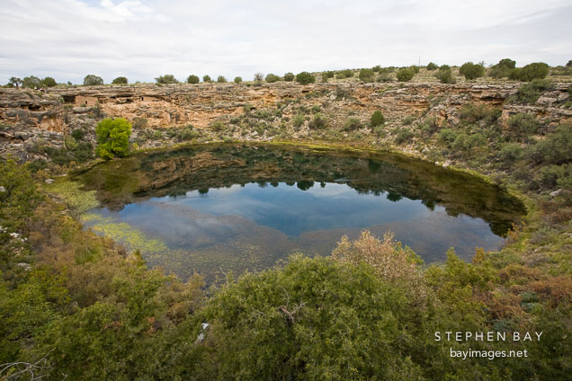 The well is a limestone sinkhole created by the collapse of an underground cavern. Montezuma Well, Arizona.