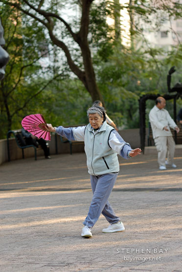 Practicing Tai Chi with a fan. Hong Kong, China.