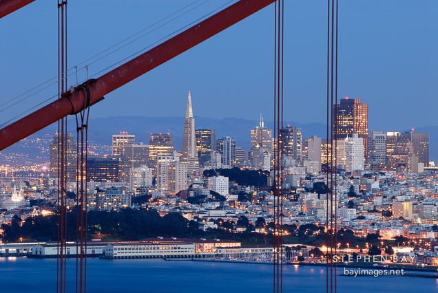 San Francisco skyline seen throught the cables of the Golden Gate Bridge. California, USA.