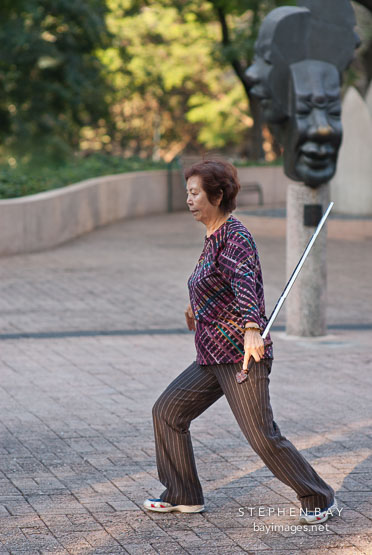 Tai Chi exercise with sword. Kowloon park, Hong Kong, China.