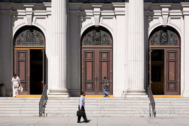 People walking by the church doors. Cathedral Basilica of St. Joseph, San Jose, California.