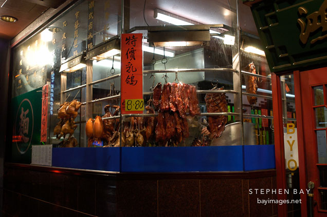 Duck and pork meat hanging in the window of chinatown restaurant, Melbourne, Australia.