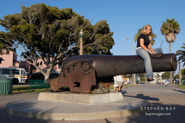 Girl sitting on a Cannon. Palisades Park, Santa Monica, California, USA.