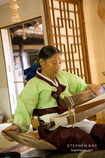 Weaving cotton into cloth using a hand loom is very labor intensive. This woman demonstrates the process at the Korean Folk Village.