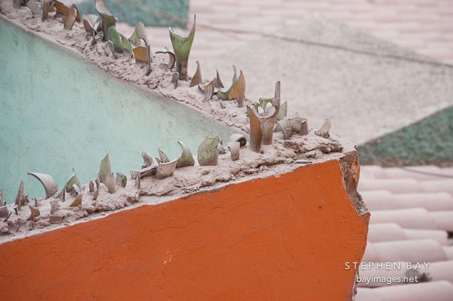 Broken bottles on top of wall surrounding a residence. Miraflores, Lima, Peru.