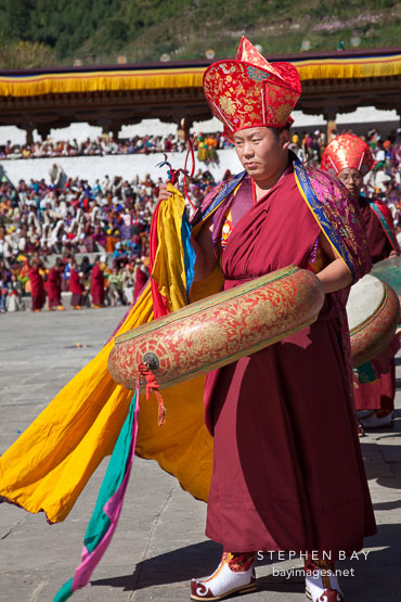 Monk holding large drum. Thimphu tsechu, Bhutan.