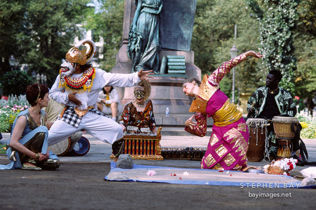 Man in animal costume dances with the golden woman. Helsinki, Finland.