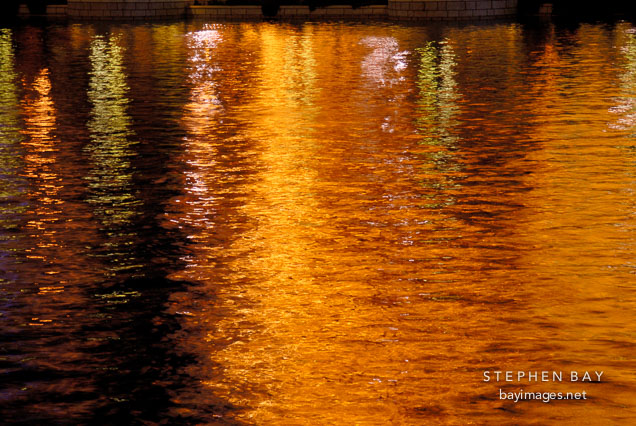 Orange reflections of lights from the strip onto water. Las Vegas Boulevard, USA.