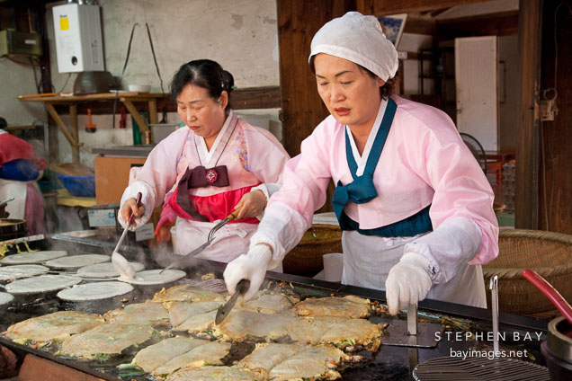These women are preparing haemul pajeon, Korean pancakes filled green onions and seafood.
