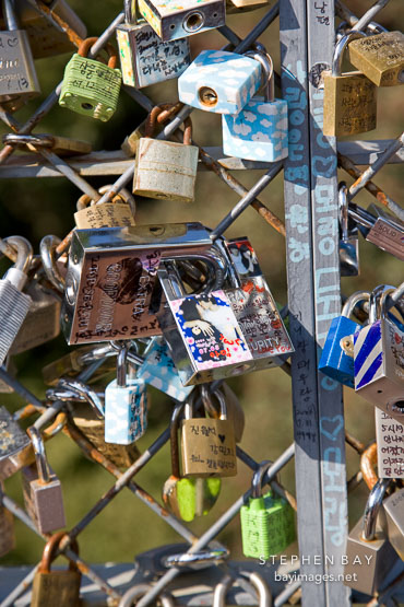 A close-up view of love locks that cover the fences on the outdoor observation decks on N Seoul Tower in Seoul, South Korea. Each lock bears the names of a couple.