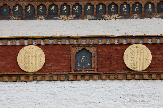 Slate carving and gilded relief disks at Druk Wangyal Chorten.