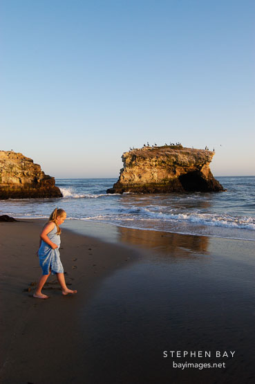 Girl at Natural bridges state beach, California, USA.
