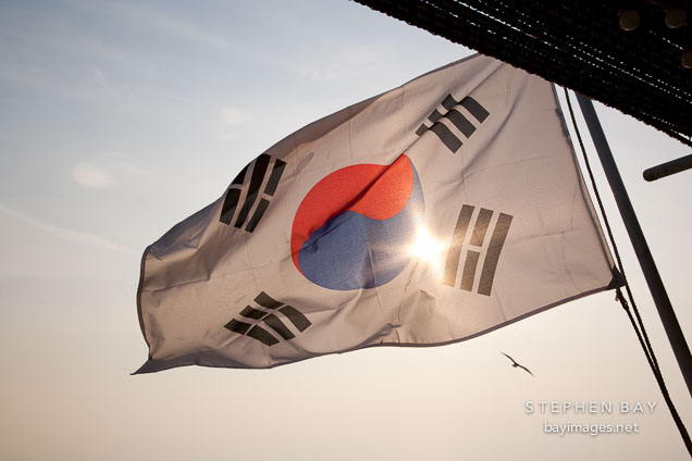 Taegukgi, the flag of the Republic of Korea, waves in the breeze on a boat in the harbor at Wolmido in Incheon, South Korea.