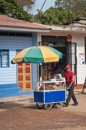 Young man with food cart. Puerto Maldonado, Peru.