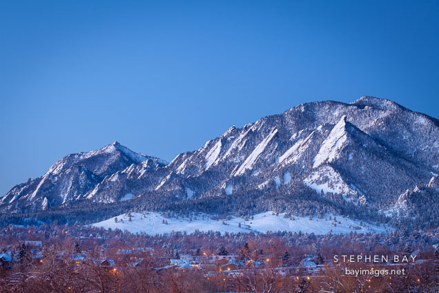 Flatirons and the city of Boulder in winter just before sunrise. Boulder, Colorado.