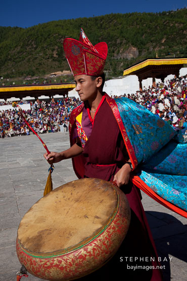 Monk beating large drum. Thimphu tsechu, Bhutan.