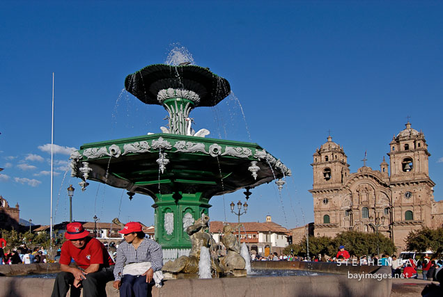 Fountain in Plaza de Armas and Iglesia de la Compania de Jesus. Cusco, Peru.