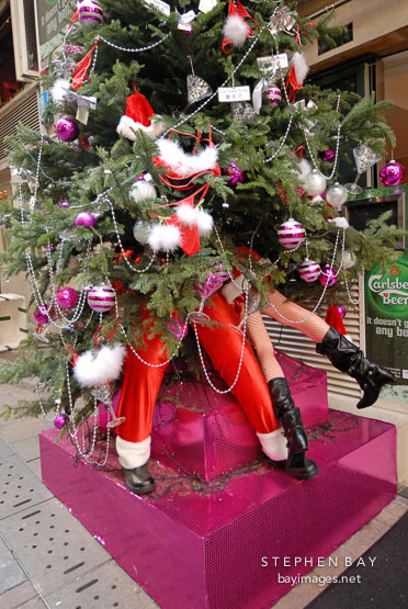 Santa Claus and girl under a christmas tree. Lan Kwai Fong. Hong Kong