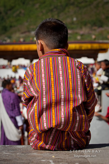 Boy wearing gho. Thimphu tsechu, Bhutan.