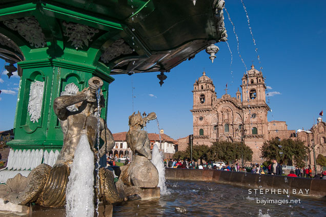 Fountain in Plaza de Armas and Iglesia de la Compania de Jesus. Cusco, Peru.