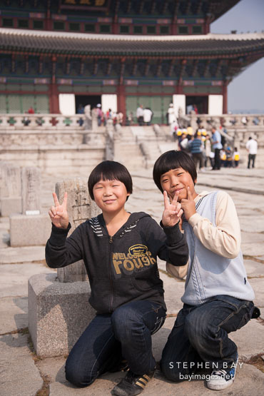 Korean schoolchildren stop to pose for a picture in front of Geunjeongjeon during a tour of Gyeongbok Palace in Seoul, South Korea.