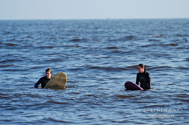 Two surfers waiting for the wave. Venice, California, USA.