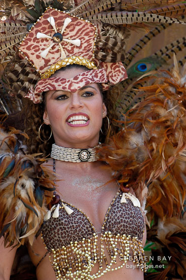 Woman with feathered headdress. Carnaval's grand parade. San Francisco, California, USA.