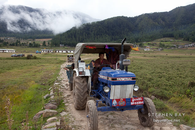 Farmer driving tractor in Phobjikha Valley, Bhutan.