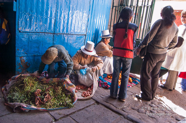 Selling produce by the entrance to the central market. Cusco, Peru.