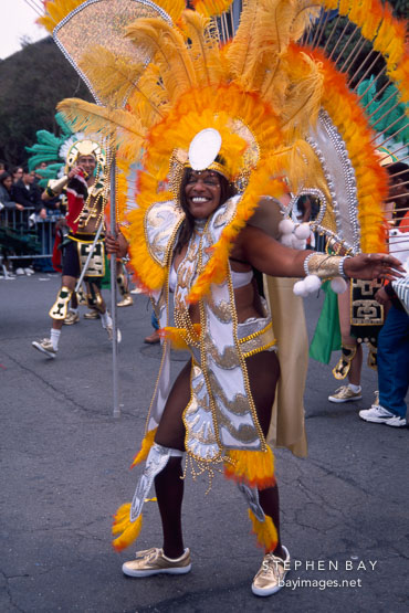 African-American women in costume with bright orange feathers. Carnaval's grand parade. San Francisco.