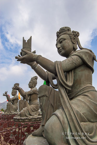 Buddhist statues praising the Tian Tan Budha. Lantau Island, Hong Kong, China.