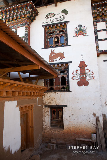 Paintings on the side of a house including a penis, deer,  garuda, and snow lion. Sopsokha, Bhutan.
