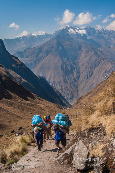 Photo: Porters carrying heavy loads up the Inca Trail.