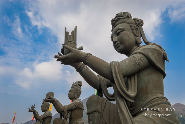 Buddhist statues praising the Tian Tan Budha. Lantau Island, Hong Kong, China.