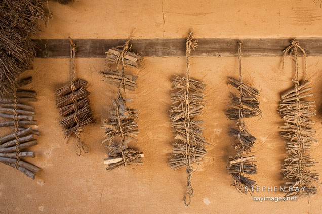 Bundles of sticks hang outside a traditional home in the Korean Folk Village.