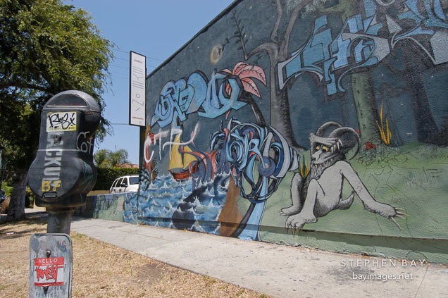 Parking meter and graffiti mural. Los Angeles, California, USA.