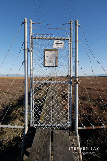 Fence and maintenance boardwalk at the Palo Alto Baylands. California, USA.