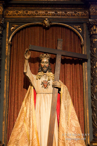 Jesus as king of kings holding cross. Carmel Mission, California.