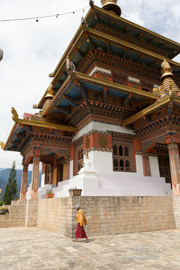 Khamsum Yuelley Namgyal Chorten and old woman. Punakha valley, Bhutan.