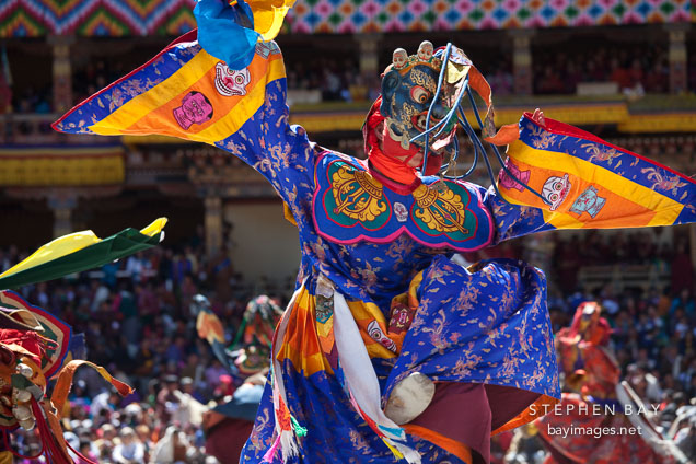 Dancer with terrifying mask and brocade dress. Thimphu tsechu, Bhutan.