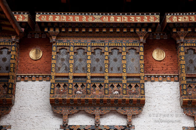 Windows on the walls of the southernmost courtyard at Punakha Dzong. Punakha, Bhutan.