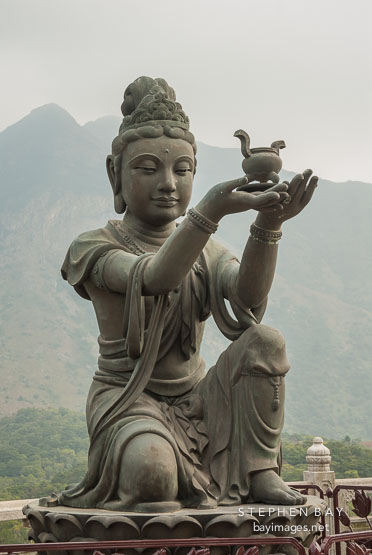 Buddhist statues praising the Tian Tan Budha. Lantau Island, Hong Kong, China.