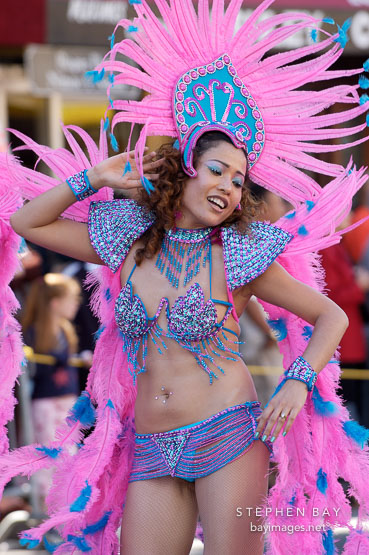 Woman in costume with pink feathers. Carnaval's grand parade. San Francisco, California, USA.