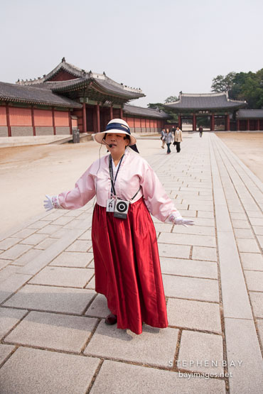 A tour guide speaks to visitors at Changdeok Palace in Seoul, South Korea.